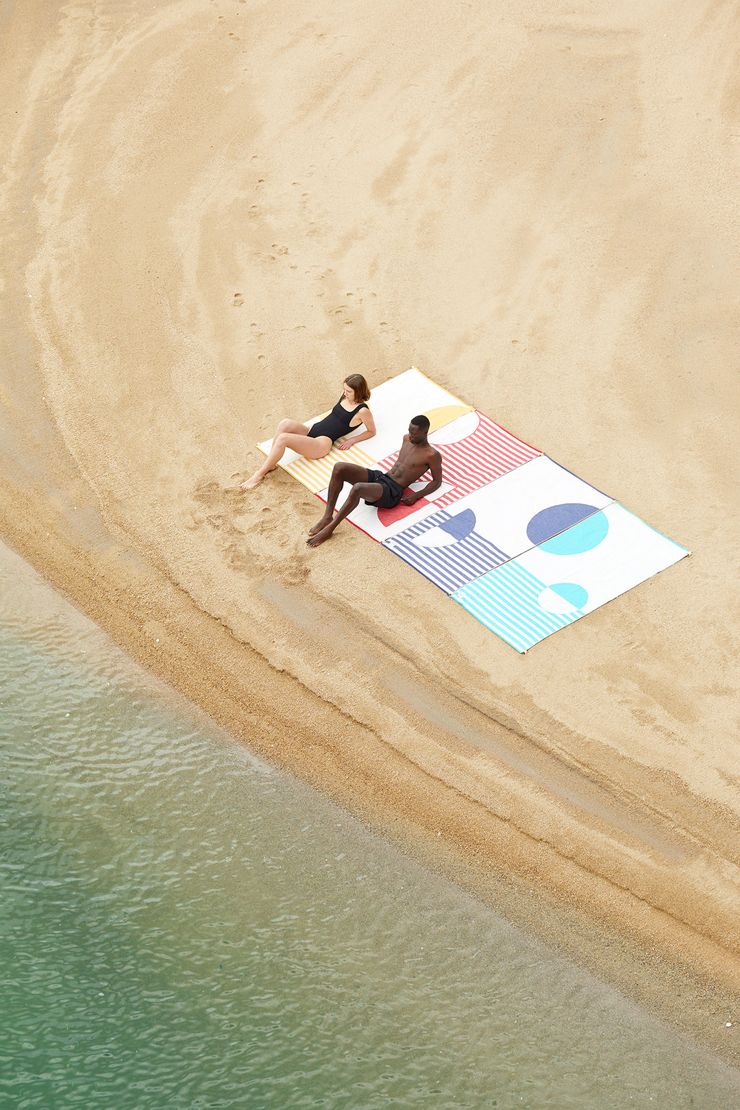 Four beach towels connected together with each other creating a wide space on the beach. The Moon collection of premium light beach towels made of organic cotton. An extra large beach towels created by linking designs with no sand in between.