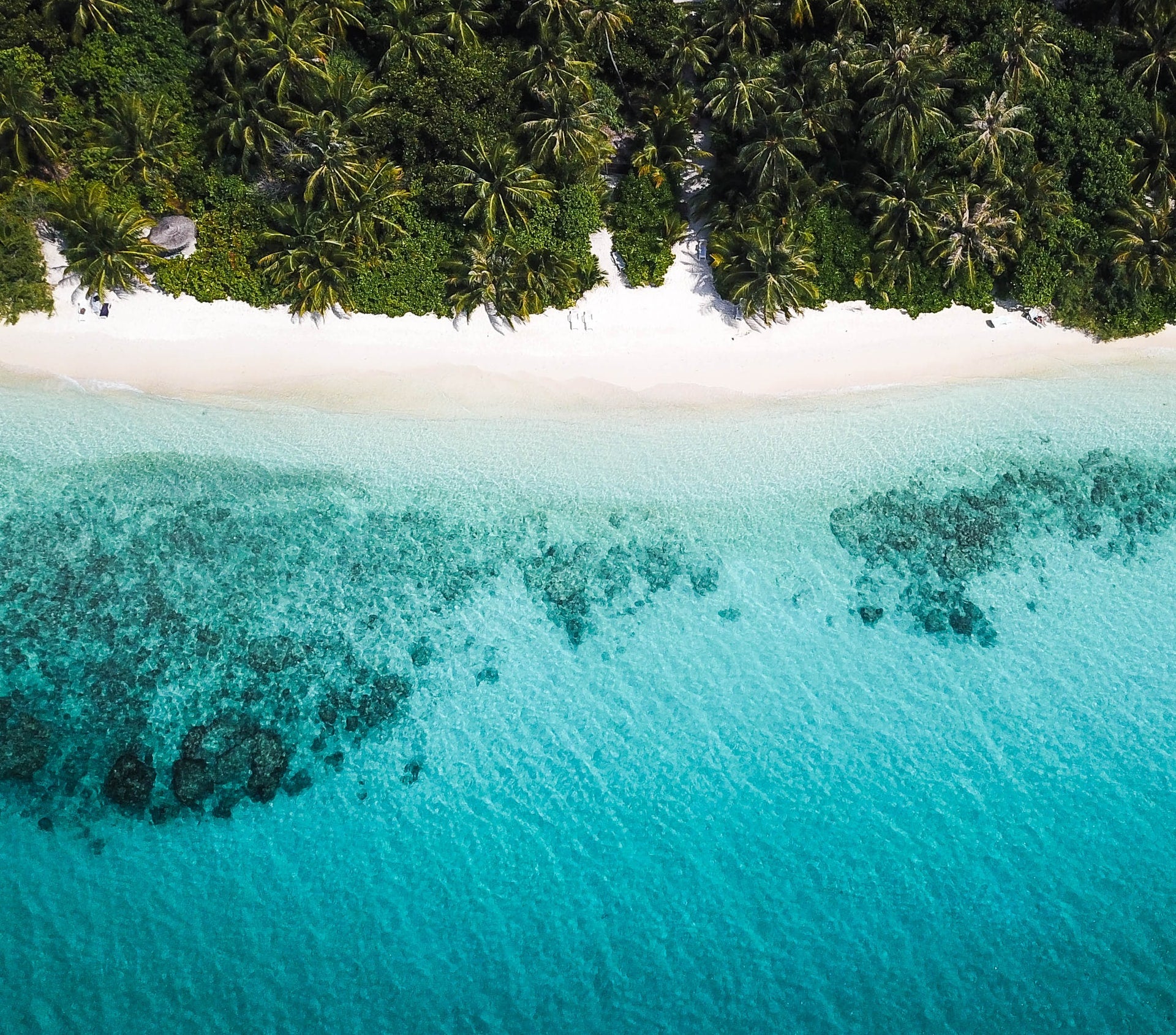 Beautiful beach picture from a dron view. Cristal water and wite sand great to imagine several tucca beach towels connected together.