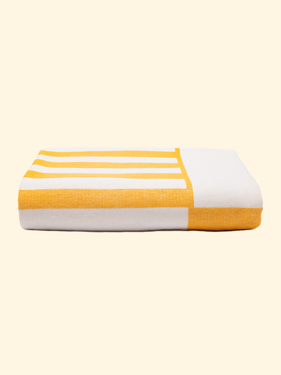 Model Danai of Tucca light beach towel 100% organic cotton, perfectly folded as presented on the packaging. Showing that is a very thing beach towel easy to carry.