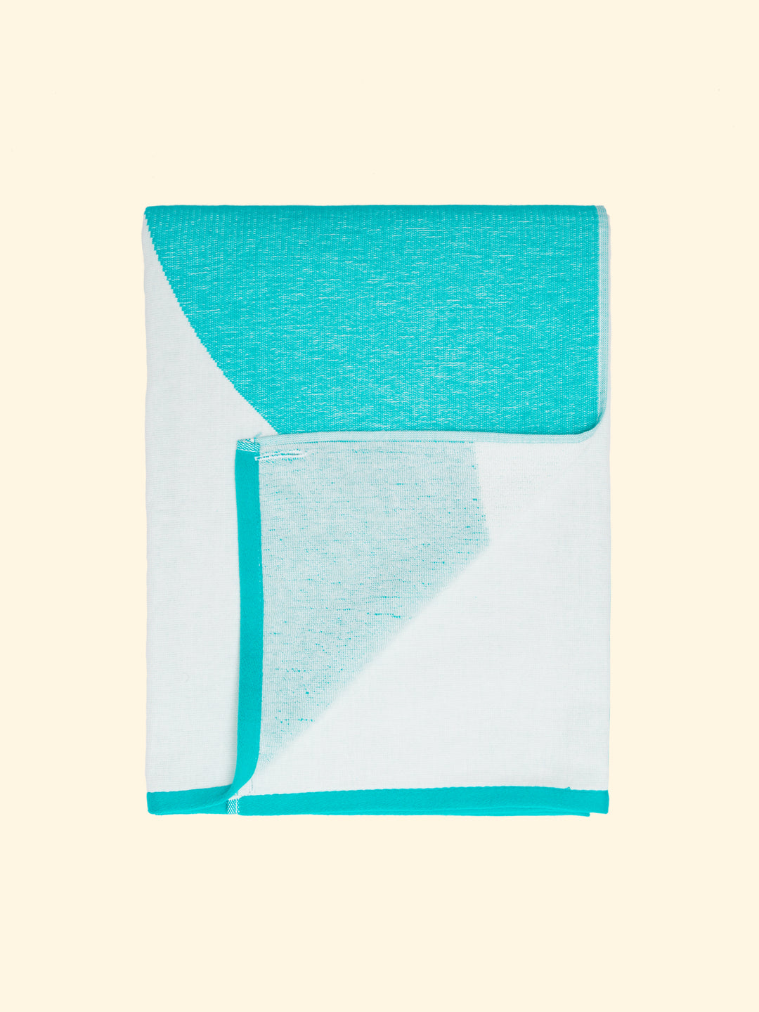 Model “Mayeri” of Tucca light beach towel, 100% organic cotton, folded while the top side is completely flat and fresh and the underside one woven with terry. All woven, not printed, for optimal drying and preservation of color