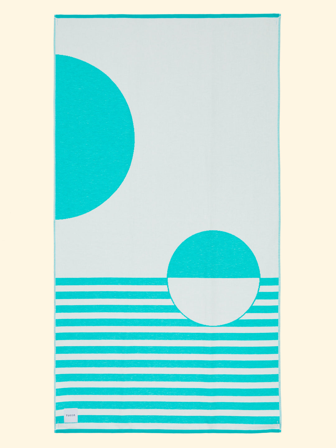 Tucca “Mayeri” extra light beach towel extended. Light mustard yellow and white colors in big blocks composing a beautiful design. Large beach towel that doesn't get blown by the wind. Super soft texture as it is made with 100% organic cotton.