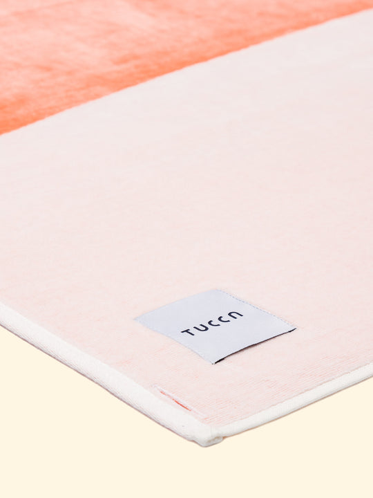 Model “Konoh” of Tucca beach towel 100% organic cotton, folded while showing the top side finished in terry velour, making it softer and lighter.