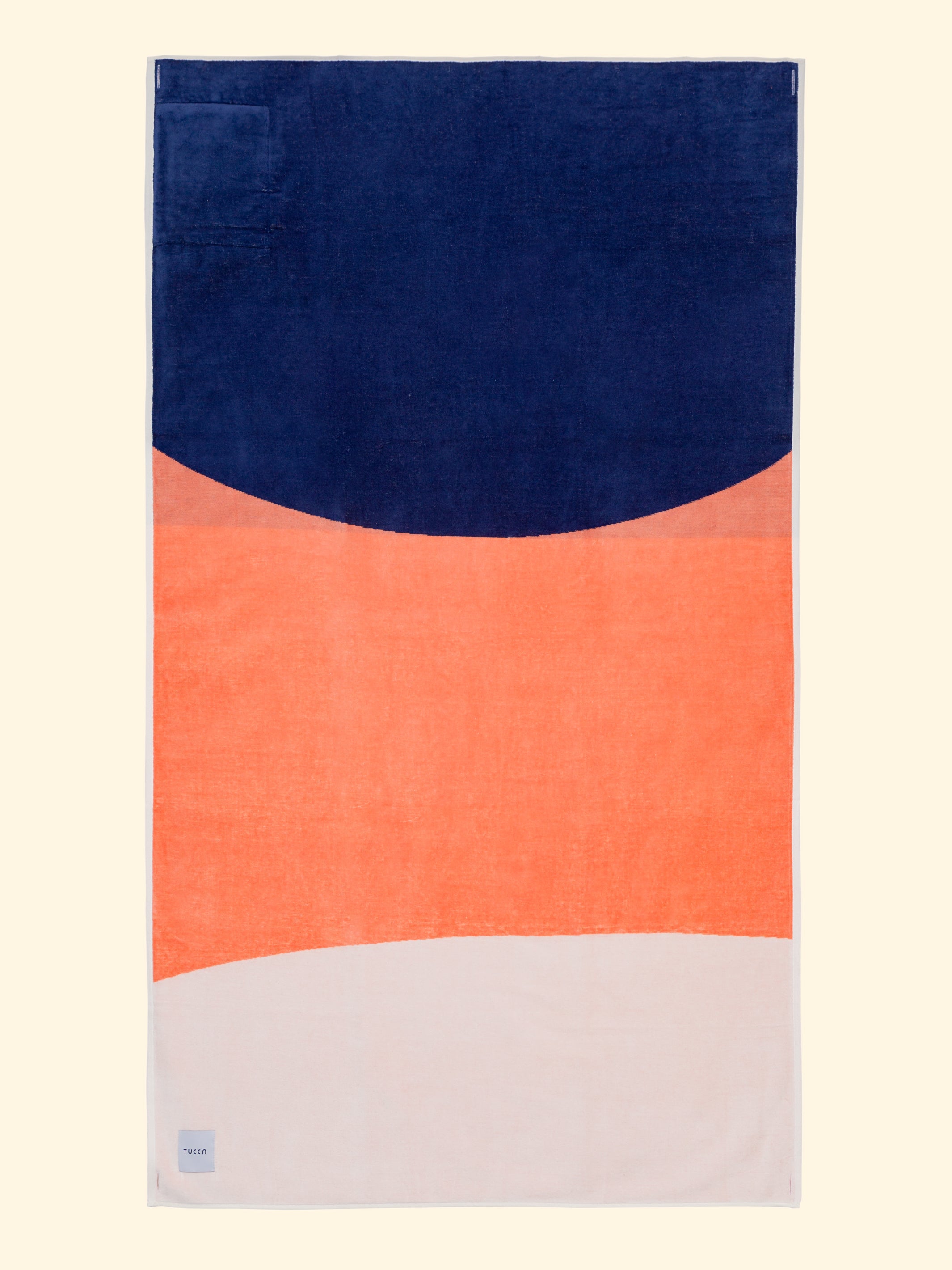 Tucca "Konoh" beach towel extended. Dark blue, creamy pink and white colors in big blocks composing a beautiful design. Large beach towel that doesn't get blown by the wind. Super soft texture as it is made with 100% organic cotton.